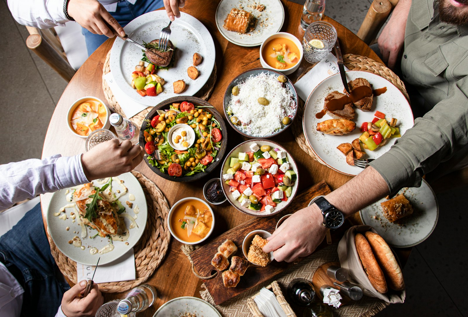 A family enjoying a variety of dishes together at a round table