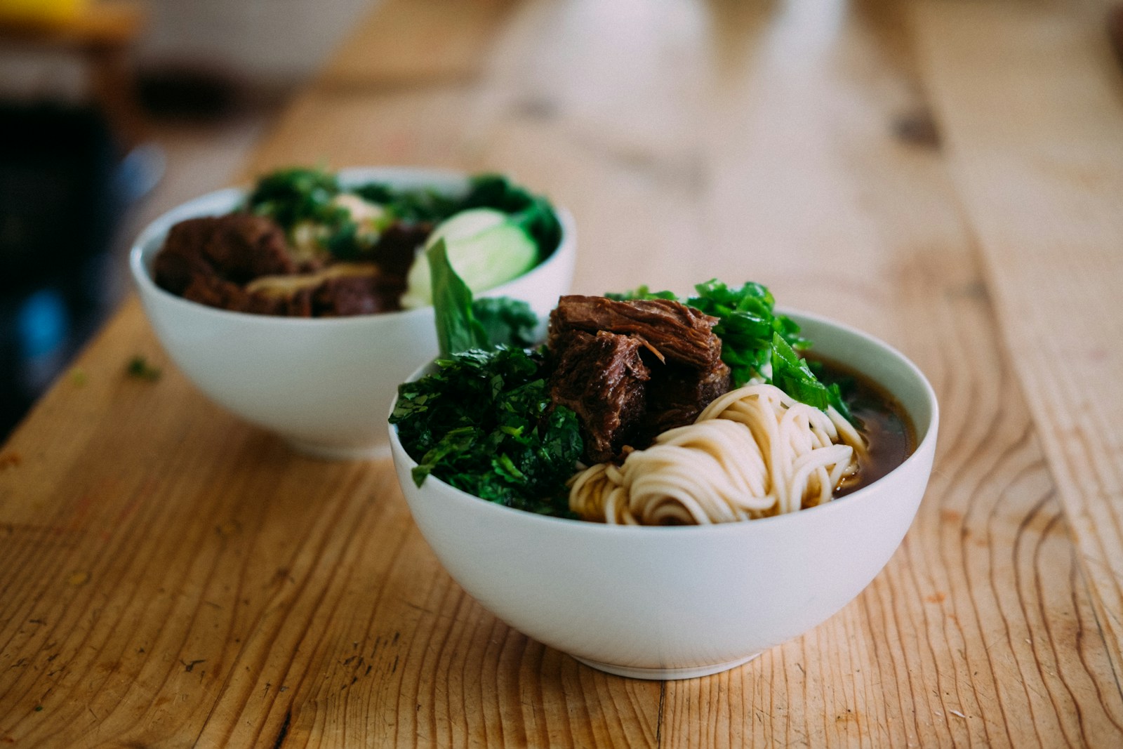 A bowl of noodle soup with chopsticks